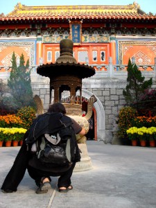 Devotee offering prayer at Buddhist Monastery Hong Kong