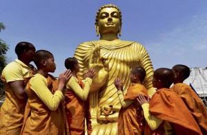 Devotees pay obeisance before a statue of Lord Buddha on the occasion of Buddha Purnima, in Bhopal on May 3, 2015.