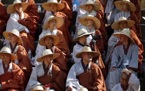 A Buddhist monk takes photographs of his fellow monk before a lotus lantern parade in celebration of the upcoming birthday of Buddha in Seoul, South Korea, on May 16, 2015.