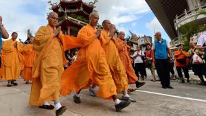 Monks leading devotees pray outside the Kong Meng San Phor Kark See Monastery (KMSPKS) during a ritual on the eve of Vesak day in Singapore. Vesak Day commemorates the birth, enlightenment of Buddha, and is celebrated by Buddhists in Asia