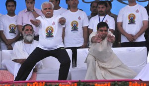 Haryana Chief Minister Manohar Lal Khattar being guided by Bal Krishan (right) at a state a function to mark the International Yoga Day in Karnal on June 15, 2015