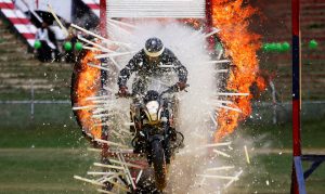 A policeman rides through a wall of fluorescent tubes during Independence Day celebrations in Srinagar.