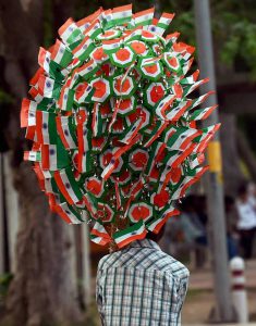 A vendor carries Tricolours on the occasion of 70th Independence Day in New Delhi