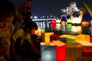 Children release lanterns into the Motoyasu river in front of the Atomic Bomb Dome to remember the atomic bomb victims on the 70th anniversary of the bombing of Hiroshima, western Japan, August 6, 2015.