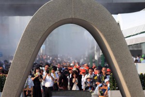 People offer prayers before a memorial monument during the 70th memorial service for the atomic bomb victims at the Peace Memorial Park in Hiroshima on August 6, 2015.