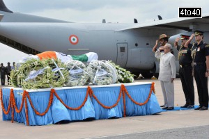 In this photograph received from the Presidential Palace on July 28, 2015, President Pranab Mukherjee pays his last respects at the body of former President APJ Abdul Kalam at Palam Air Force Station in New Delhi on July 28, 2915, after its arrival from Guwahati.