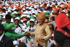 Prime Minister Narendra Modi (C) is greeted as he walks among schoolchildren after delivering his Independence Day speech from The Red Fort in New Delhi on August 15, 2015.