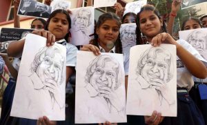 Students hold up sketches of former president APJ Abdul Kalam to mark his 85th birth anniversary at Scholar Fields Public School on October 15, 2016.