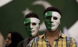 Youngsters wear masks painted in the design of the national flag