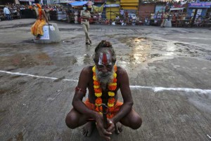 A sadhu or a Hindu holy man waits to take a holy dip in the waters of Godavari river during the second ‘Shahi Snan’ (grand bath) at the Kumbh Mela or Pitcher Festival in Nashik on September 13, 2015