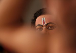 An artist dressed as Hindu Lord Krishna waits to perform in a play during the celebrations on Janmashtami, a festival that marks the birth anniversary of Hindu Lord Krishna, in New Delhi on September 4, 2015