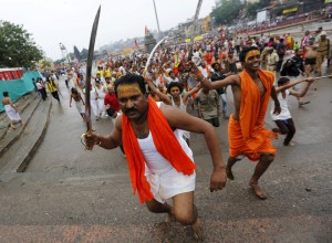 Sadhus or Hindu holy men hold swords as they run towards the banks of Godavari river to take a dip during the second ‘Shahi Snan’ (grand bath) at Kumbh Mela or Pitcher Festival in Nashik, on September 13, 2015