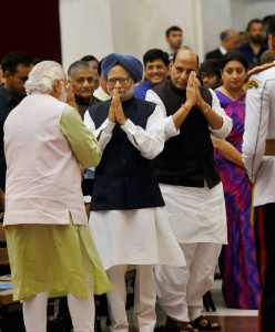 Prime Minister Narendra Modi greets former Prime Minister Manmohan Singh as Union Home Minister Rajnath Singh and Union Human Resource Development Minister Smriti Irani look on during an investiture ceremony at Rashtrapati Bhawan in New Delhi on March 28, 2016