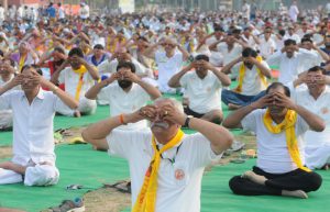 People perform yoga on the occasion of 2nd International Yoga Day at Karna stadium in Karnal