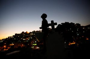 A boy holds his kite inside a cemetery in the Vila Operaria Favela of Rio de Janeiro, Brazil.