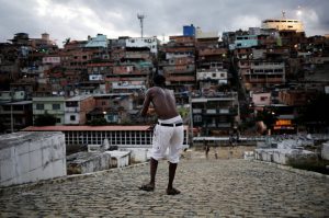 A man flies his kite in a cemetery in the Vila Operaria Favela of Rio de Janeiro, Brazil.