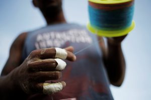 A man reels the line of his kite in a cemetery in the Vila Operaria Favela of Rio de Janeiro, Brazil.