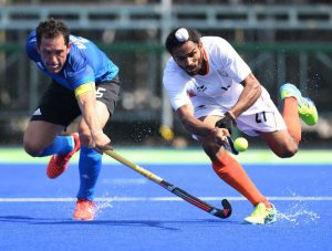 Argentina’s Pedro Ibarra (L) and India’s Akashdeep Singh stretche for the ball during the mens field hockey Argentina vs India match of the Rio 2016 Olympics Games at the Olympic Hockey Centre in Rio de Janeiro on August 9, 2016.