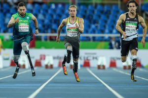 Brazil's Alan Fonteles Cardoso Oliveira (L), Germanys Johannes Floors (C) and New Zealands Liam Malone compete during a heat of mens 100 m (T44) of the Rio 2016 Paralympic Games at Olympic Stadium in Rio de Janeiro on September 8, 2016.