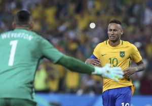 Brazil’s goalkeeper Weverton and forward Neymar react after winning the gold medals at Rio 2016 Olympic Games men’s football gold medal match between Brazil and Germany at the Maracana stadium in Rio de Janeiro on August 20, 2016