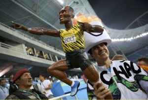 Fans hold a figure of Usain Bolt of Jamaica in the stands after Bolt won the gold medal in the men's 100m final.