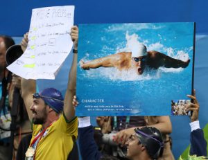 Fans hold placards in support of USA’s Michael Phelps in the Men’s 4 x 100-meter medley relay final during the swimming competitions at the 2016 Summer Olympics, August 14, 2016, in Rio de Janeiro, Brazil.