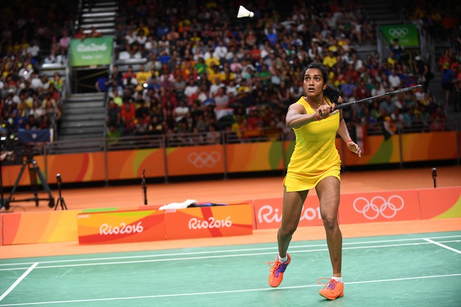 India’s Pusarla V. Sindhu returns against Spains Carolina Marin during their womens singles Gold Medal badminton match at the Riocentro stadium in Rio de Janeiro on August 19, 2016, for the Rio 2016 Olympic Games.