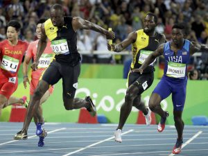 Jamaica’s Nickel Ashmeade, second right, passes the baton to Usain Bolt in the men’s 4 x 100-meter relay final at the Olympic stadium in Rio de Janeiro, Brazil, on August 19, 2016