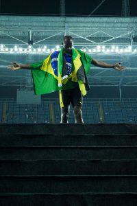 Jamaica’s Usain Bolt poses with the Jamaican flag after Team Jamaica won the men’s 4x100m Relay Final during the athletics event at the Rio 2016 Olympic Games at the Olympic Stadium in Rio de Janeiro on August 19, 2016