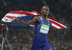 Jeff Henderson of United States celebrates by running with a flag after his gold medal win in Men’s long jump at the Olympic Stadium in Rio de Janeiro, Brazil, on August 13, 2016.