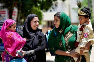 Muslim women carrying their children dressed up as Lord Krishna and Radha for a program on the eve of Krishna Janmashtami festival in Chennai.