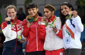 Russia’s Valeria Koblova, from left, silver medalist, Japan’s Kaori Icho, gold medalist, Tunisia’s Marwa Amri, bronze medalist, India’s Sakshi Malik pose during the medals ceremony for the women’s wrestling freestyle 58kg competition