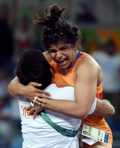 Sakshi Malik celebrates with her coach Kuldeep Singh after winning bronze against Kyrgyzstan’s Aisuluu Tynybekova in the women’s wrestling freestyle 58kg