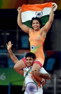 Sakshi Malik’s coach Kuldeep Singh carries her on his shoulders as they celebrate her Bronze medal against Kyrgyzstan’s Aisuluu Tynybekova in the women’s wrestling freestyle 58kg