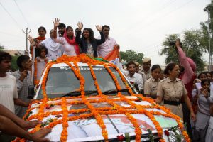 Sakshi Malik waves to a cheering crowd in Rohtak after arriving from Rio