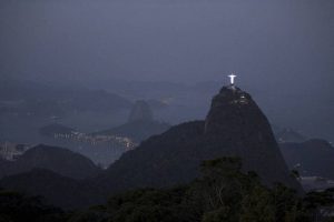 The Christ the Redeemer statue and Sugar Loaf mountain stand at dusk before the opening ceremony at the 2016 Summer Olympics in Rio de Janeiro, Brazil on August 5, 2016.