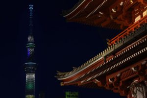 The historic Sensoji temple (R) is seen in the foreground as the landmark Tokyo Skytree (L), the tallest structure in Japan, is illuminated in the yellow and green colours of the Brazilian flag in Tokyo on August 4, 2016, to celebrate the Rio de Janeiro Olympic and Paralympic Games.