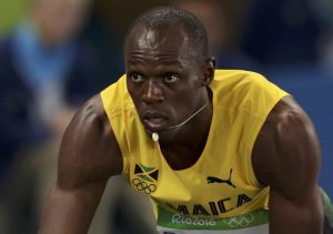 Usain Bolt of Jamaica gets into the starting blocks.