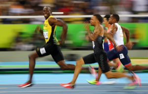 Usain Bolt of Jamaica looks at Andre De Grasse of Canada as they compete in the semifinal of the Men’s 100m.