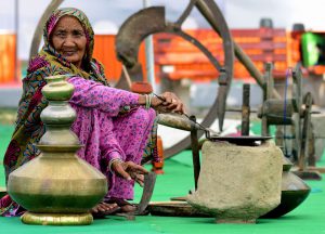 An elderly displays Haryana’s traditional articles at an exhibition organised during 31st state level Haryana Day celebration 'Ratnawali' at Kurukshetra University in Kurukshetra.