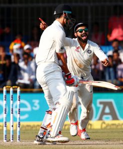 India’s Virat Kohli (R) celebrates with teammates after winning the third and the final Test cricket match against New Zealand at the Holkar Cricket Stadium in Indore.