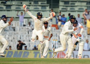 Indian cricketer Pathiv Patel (C) and Chaithishwar Pujara (R) celebrate with teammates after winning the fifth and final Test cricket match between India and England at the MA Chidambaram Stadium in Chennai on December 20, 2016.