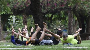 A group strikes a yoga pose at Lodhi Garden in New Delhi on June 18, 2017.