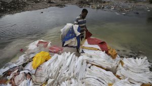 A man washes sacks used to carry limewash in a shallow on the banks of river Tawi in Jammu. In many households, safe drinking water is not a basic amenity rather a luxury especially in semi-urban and rural areas. According to a report ,each day approximately 500 million litres of wastewater from industrial sources is dumped into the rivers of India.