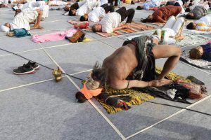 A sadhu or a holy man participates along with others in a yoga workshop conducted by the yoga guru Ramdev in Ahmedabad on June 20, 2017 ahead of the International Yoga Day.