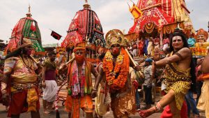 Devotees dressed up as various mythological figures near the main gate of the Puri temple