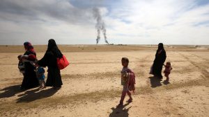 Displaced Iraqi families evacuate from the modern town of Hatra and neighbouring villages, near the eponymous UNESCO-listed ancient city, southwest of the northern city of Mosul, on April 26, 2017, as pro-government Hashed al-Shaabi (Popular Mobilisation) paramilitary forces advance during an offensive to retake the area from Islamic State (IS) group fighters. Hatra is the latest important archaeological site to be recaptured from IS. Jihadists had embarked on a campaign of destruction against archaeological sites after they seized swathes of Iraq and Syria in a lightning 2014 offensive. The full extent of the harm to Hatra remains unclear.