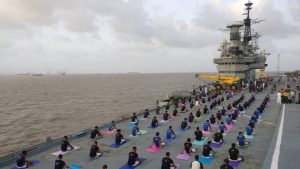 Indian Naval Cadets perform yoga on the deck of INS Virat on International Yoga Day in Mumbai, Maharashtra. Large scale yoga sessions have people across India bending and twisting into various poses on International Day of Yoga.