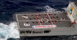 People from the Naval staff perform yoga during a yoga event to mark the 3rd International Yoga Day on the deck of INS Sunayana at Southern Naval Command (SNC) in Kochi