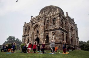 People perform yoga during the 3rd International Yoga Day at Lodhi garden in New Delhi